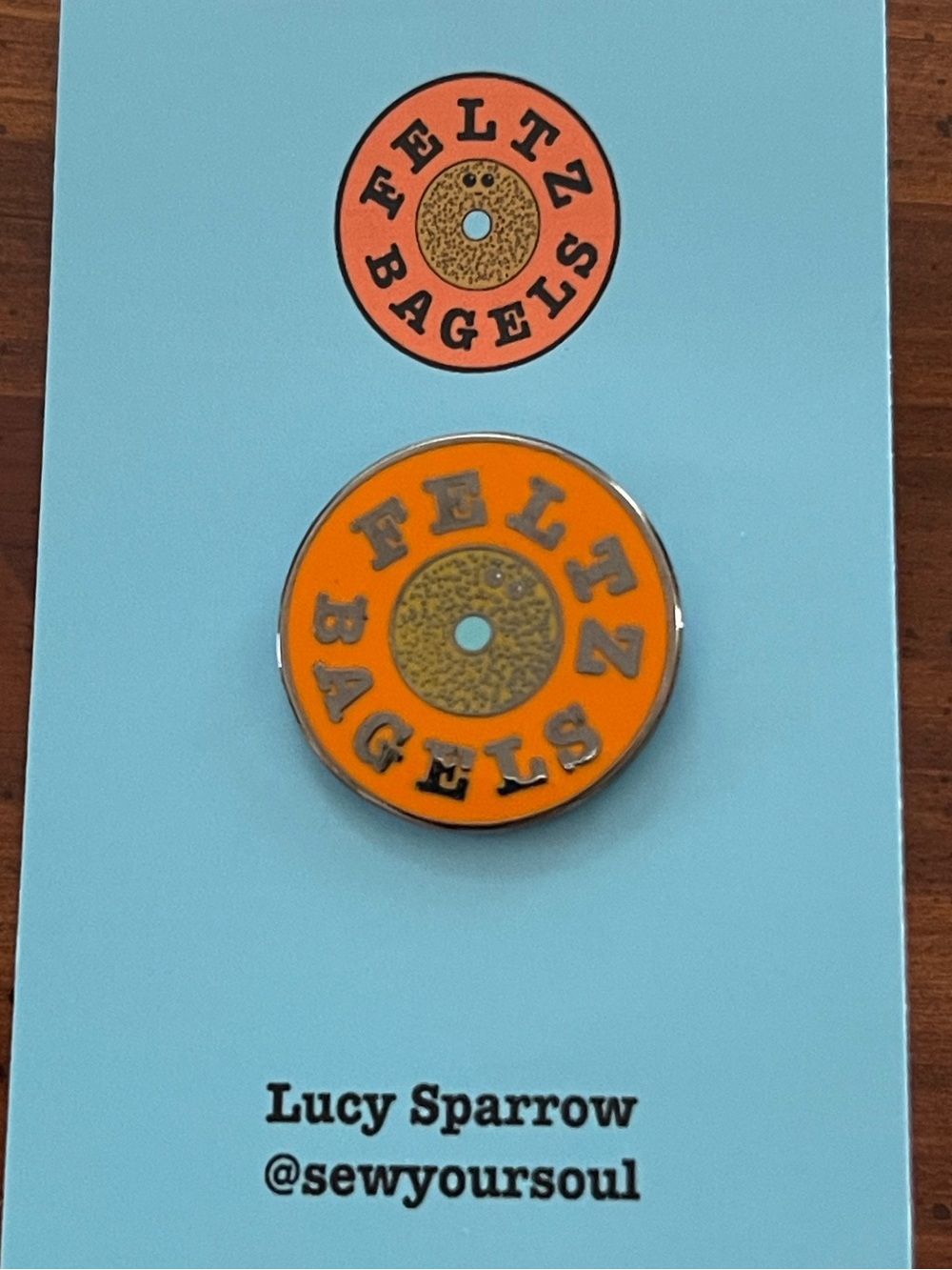 Lucy Sparrow Orange Feltz Bagels Enamel Pin